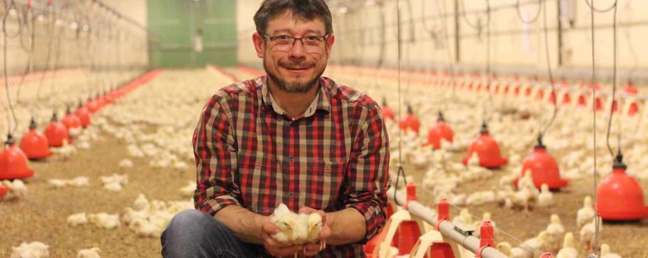 hero-poultry-man-holding-chickens