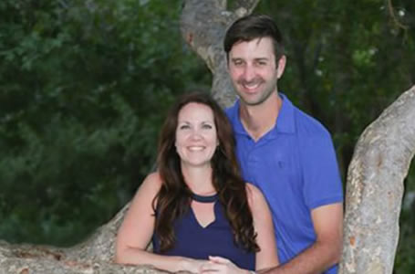 Couple standing by tree