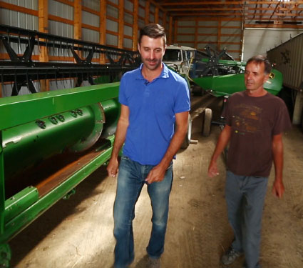 Two men in a machine shed