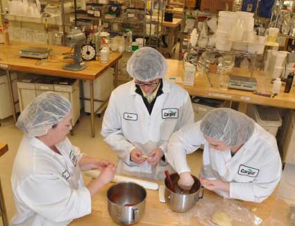 Three people working in a test kitchen