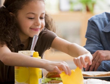 Young girl making a sandwich