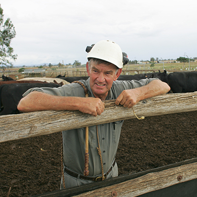 Man leaning on a fence