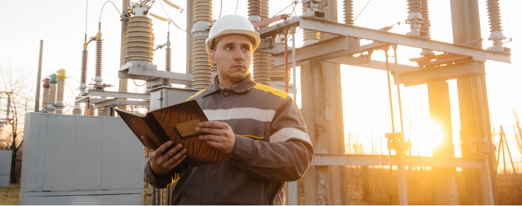 Man-standing-in-front-of-transformer-substation