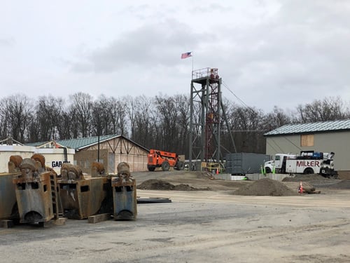 Drill bit removed. Temporary headframe roped up for shaft lining.