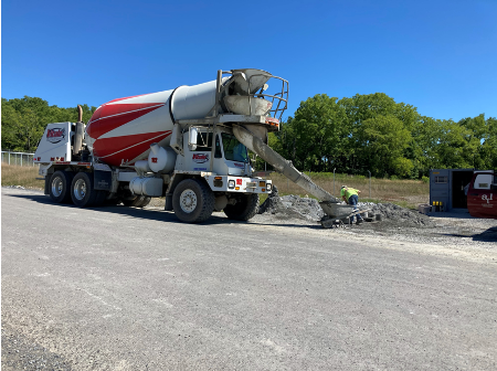 Atlantic Testing Laboratories collecting concrete sample for quality testing.