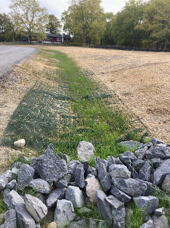 Final seeding work on the roadside drainage systems.