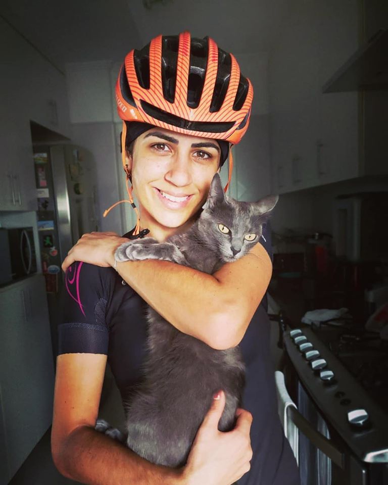 Thamys Carvalhais with bike helmet and cat image