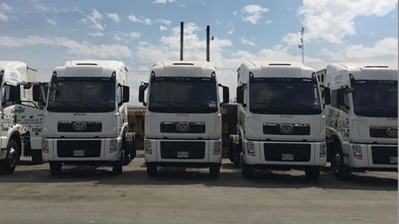 white trucks parked in row on parking zone 