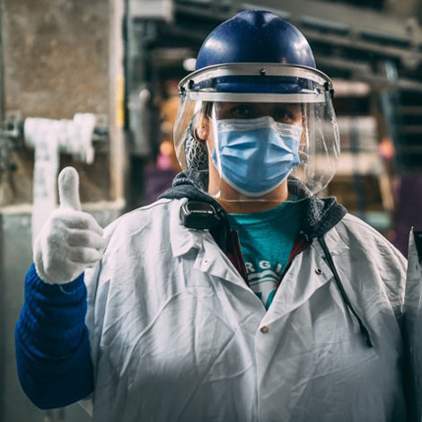 worker showing safety gear and giving a thumbs up image