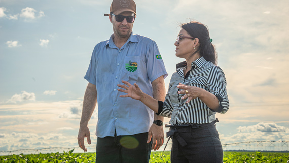 couple of people walking in a field image