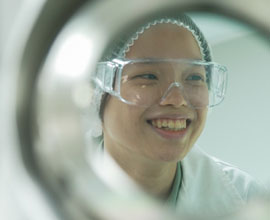 woman with safety goggles smiling image