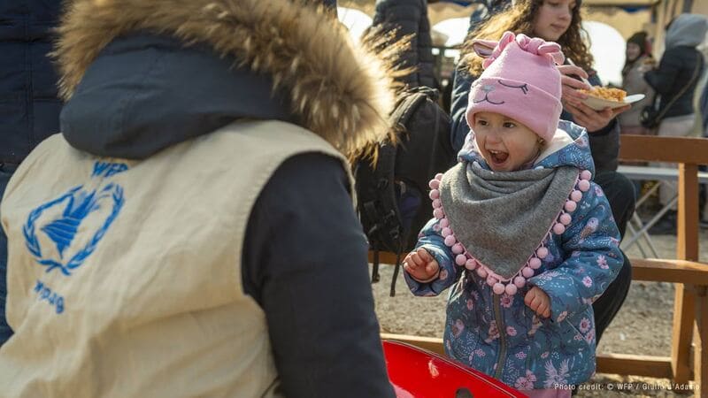 Woman wearing WFP jacket playing with a kid image