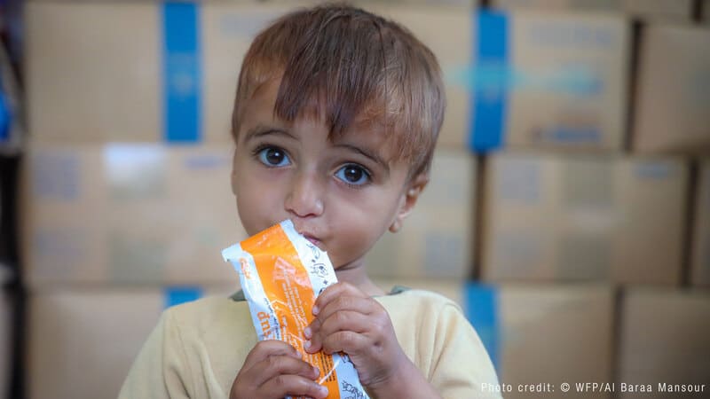 child eating food from a package image child eating food from a package image