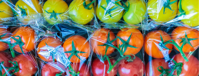 Colorful tomatoes in clear plastic packaging