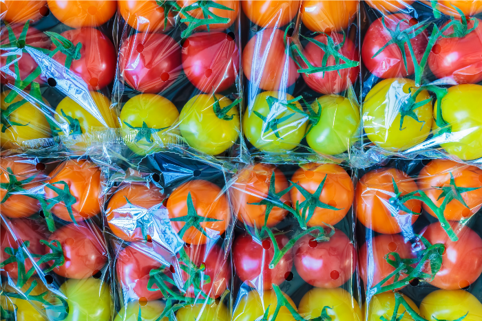 Colorful tomatoes in clear plastic packaging