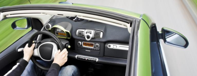 Convertible car driving on road