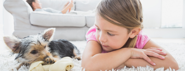 Young girl and dog on floor