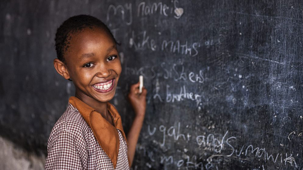 Schoolchildren drawing in a classroom.