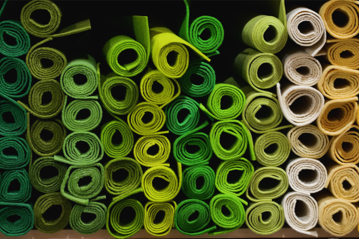 Textiles; rolled fabric in shades of green