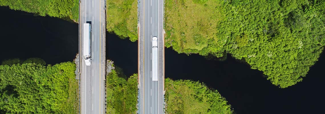 Trucks on highway above a river