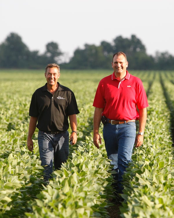 men walking in a field image