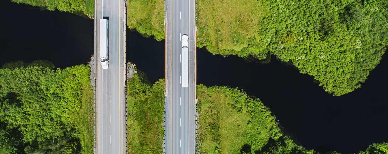 trucks on bridge over river image