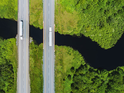 trucks on bridge over river image