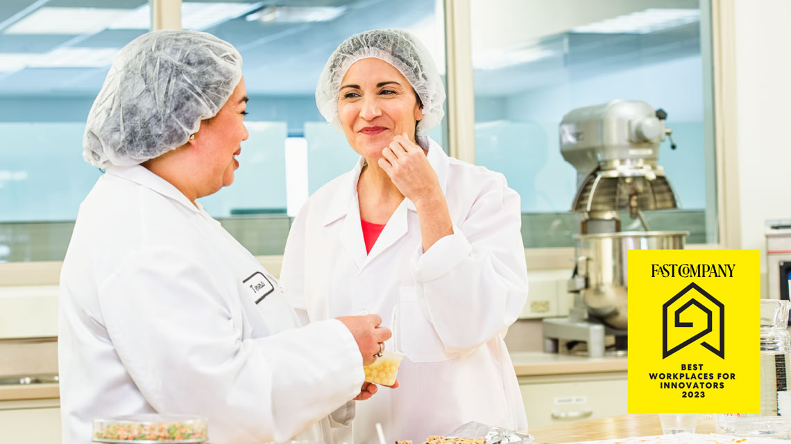 women in a lab smiling image