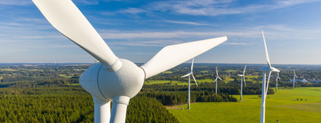 Close up of a wind turbine in a field
