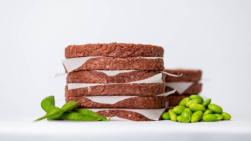 A stack of plant-based burger patties. A stack of plant-based burger patties.