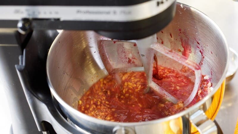 Ingredients for a plant-based burger in a mixing bowl in a kitchen. Ingredients for a plant-based burger in a mixing bowl in a kitchen.