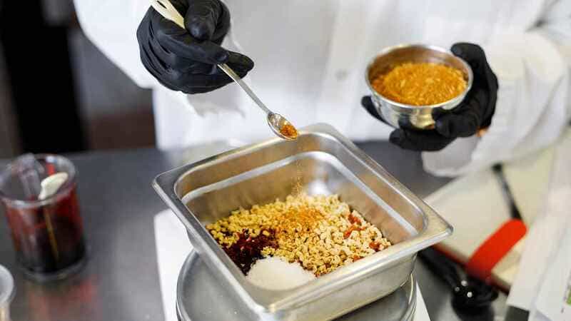 Dressed in a white lab coat, a Cargill food scientist measures and mixes the right ingredients for a plant-base burger. Dressed in a white lab coat, a Cargill food scientist measures and mixes the right ingredients for a plant-base burger.