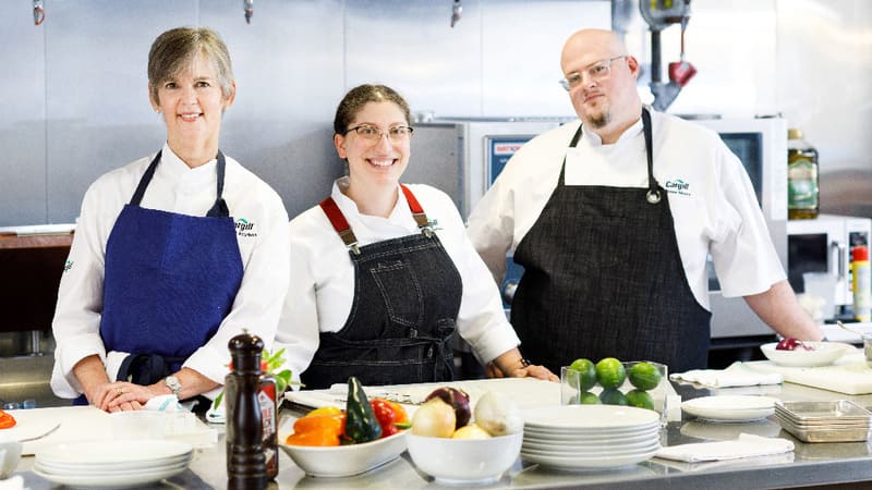 Chefs posing in kitchen Chefs posing in kitchen