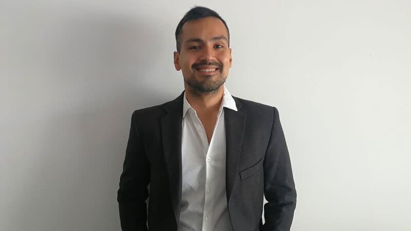 A man in a black blazer on a white background. A man in a black blazer on a white background.