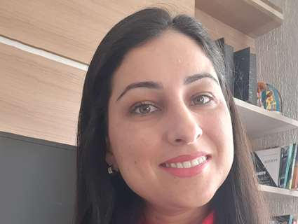 A woman with black hair smiles.