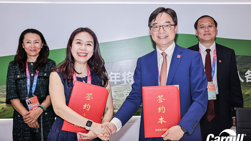 Two representatives shaking hands to fund regenerative agriculture research. 