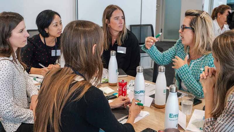 A group of women traders discuss ideas during an event organized by Cargill. 