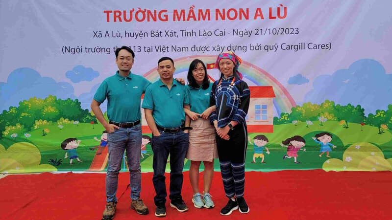 Four Cargill colleagues smile during the recent opening of a new school in Vietnam, built by Cargill volunteers. 