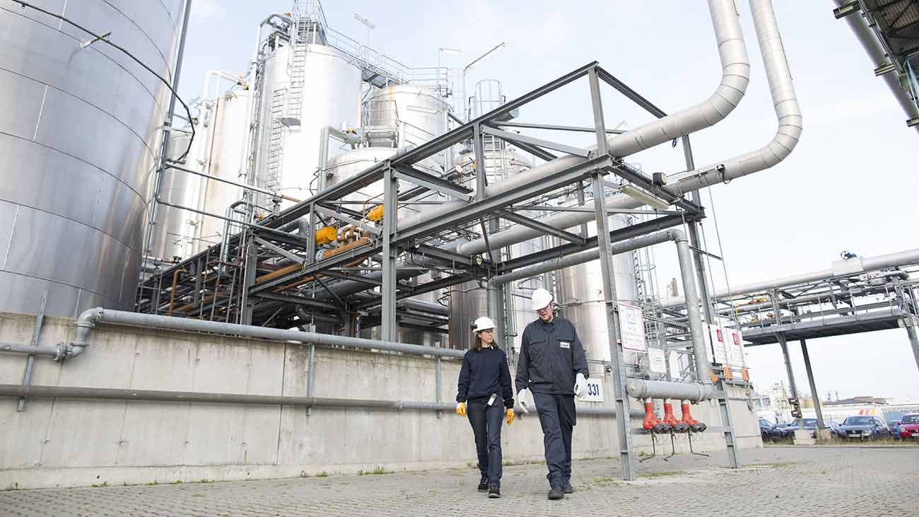 : Two Cargill employees walking the grounds of a biofuel plant in Germany.