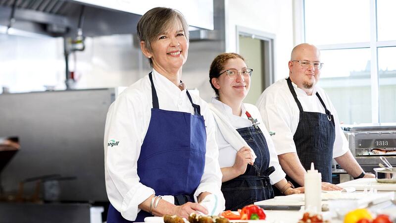 Cargill chefs standing side by side in a professional kitchen. Cargill chefs standing side by side in a professional kitchen.