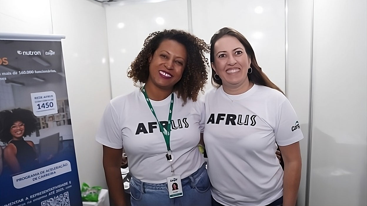 Two Cargill employees wearing matching ‘Afrus’ shirts standing next to each other.   