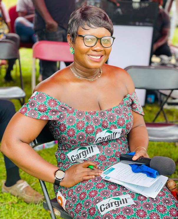 A woman posing in a sundress marked with Cargill stickers