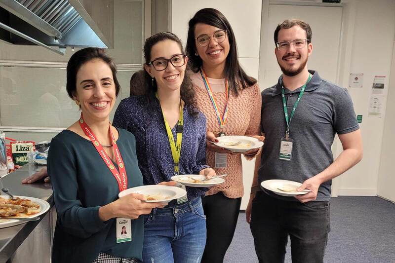 Four people stand in a food science lab after a BBQ tasting session. Four people stand in a food science lab after a BBQ tasting session.