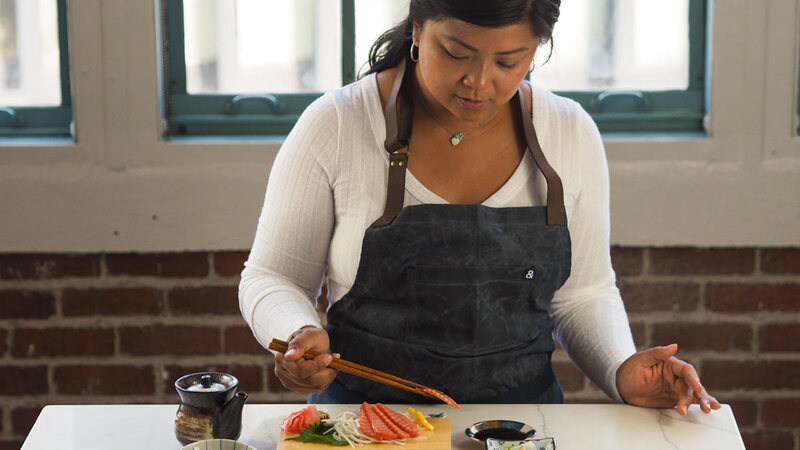 A woman plating cultivated salmon sashimi. A woman plating cultivated salmon sashimi.