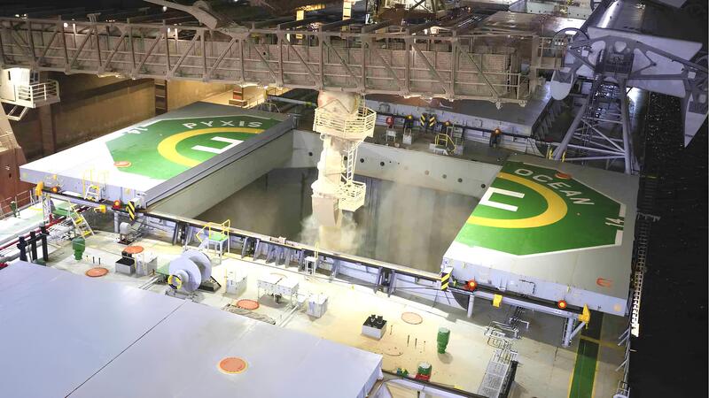 Grain flowing from a loading crane into the belly of a carrying ship. Grain flowing from a loading crane into the belly of a carrying ship.