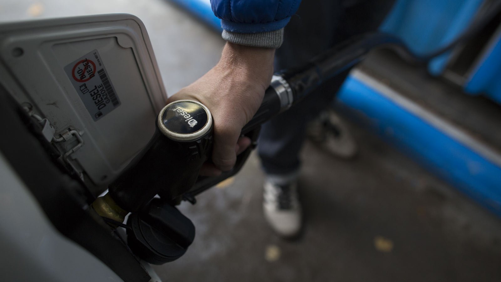 A person pumps diesel gas. 