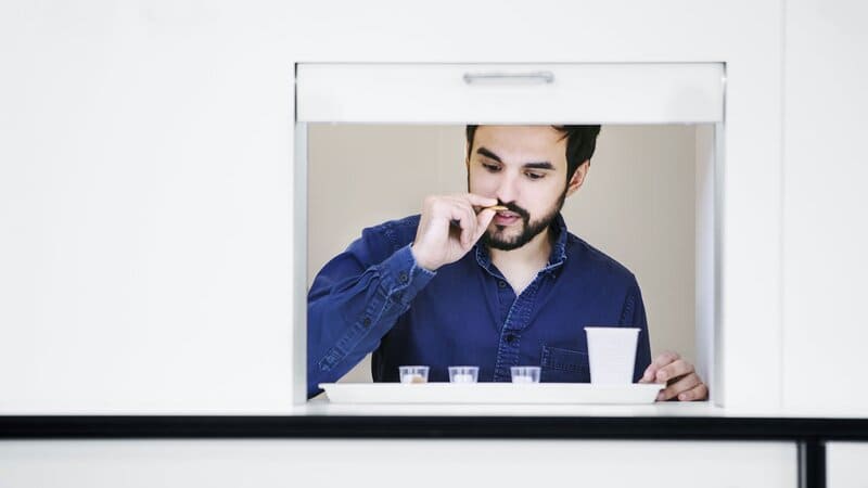 A man smells a piece of chocolate at Cargill’s House of Chocolate in Belgium.