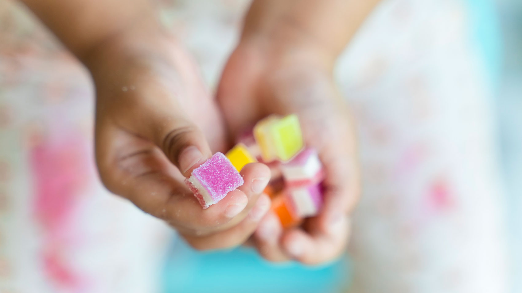 A child holds a handful of jelly candy which includes ingredients supplied by Cargill.