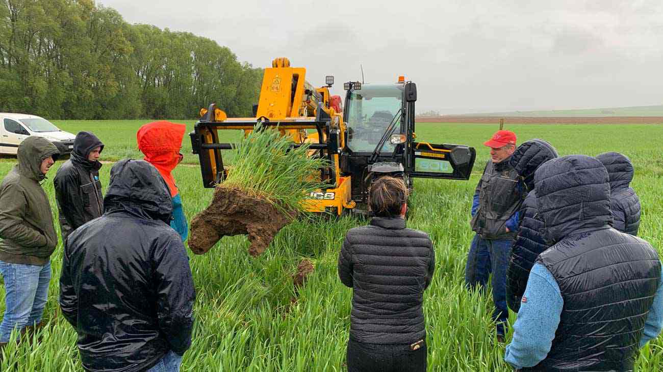 A conservation agronomist uses a machine to dig deeply into a farm field to show healthy soil to farmers. A conservation agronomist uses a machine to dig deeply into a farm field to show healthy soil to farmers.