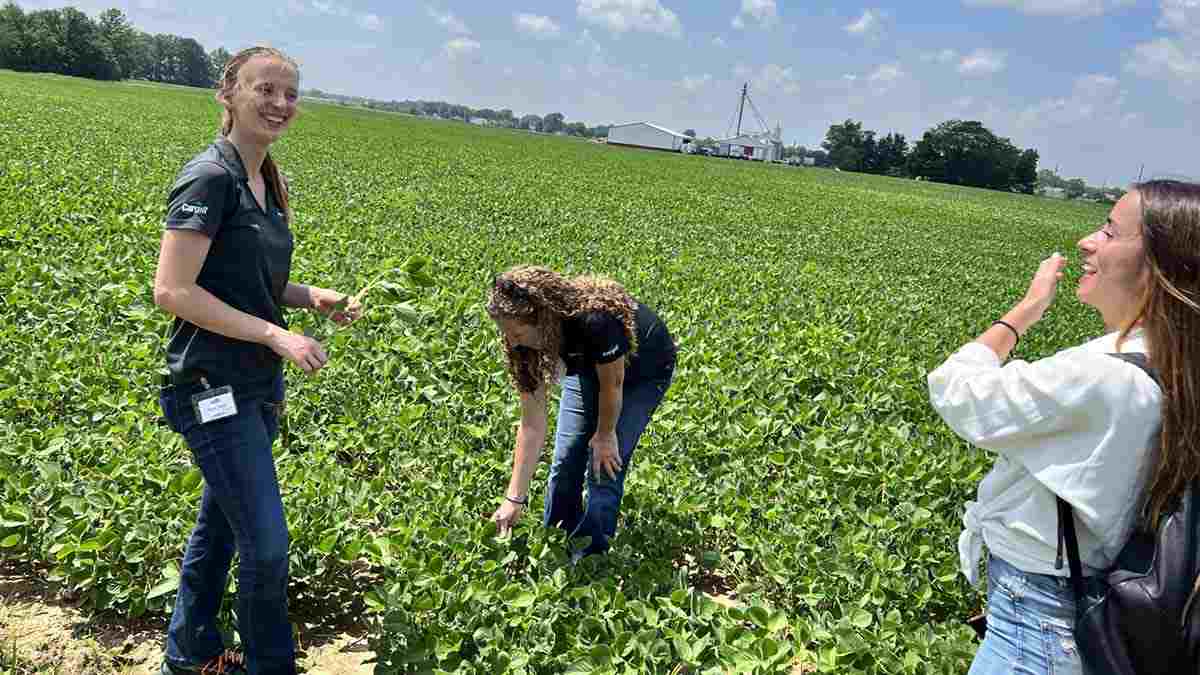 A group of people in a farm field. A group of people in a farm field.